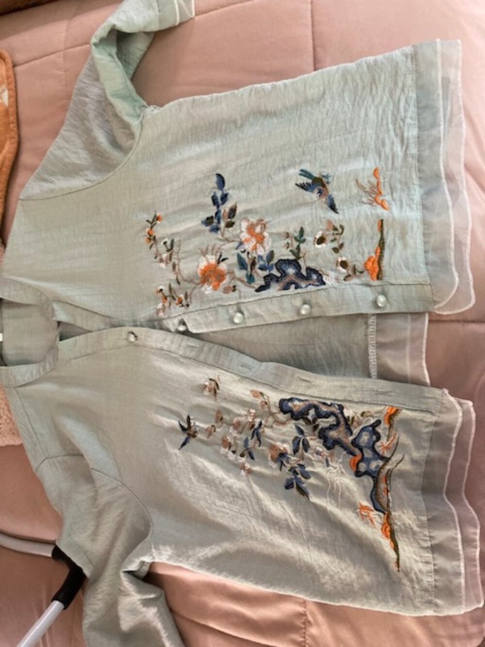 I'm selling an embroidered light green crinkled gauze top
